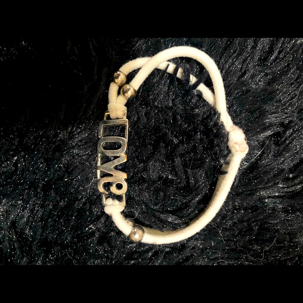 Cute bracelet says “LOVE” on a white band